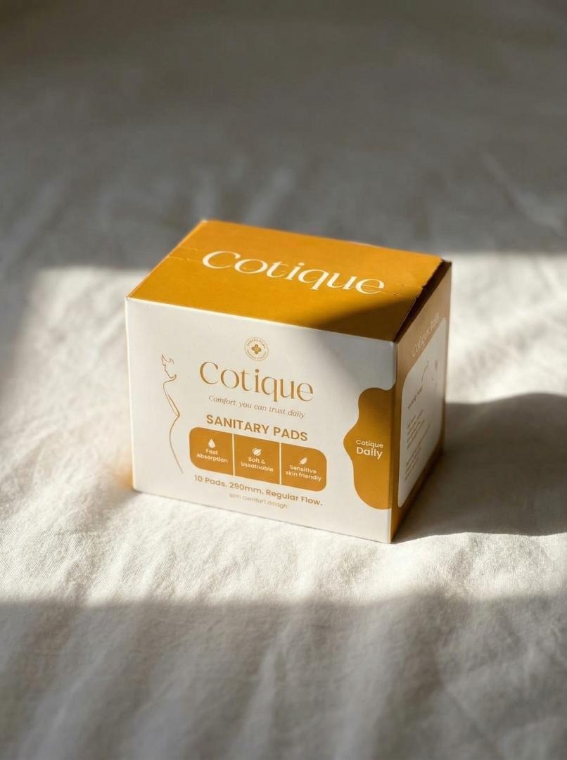 Cotique Daily packaging — amber and cream